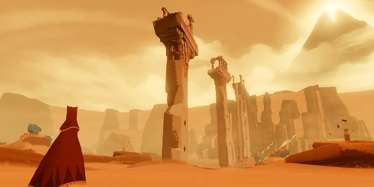 Nhân vật mặc áo choàng đỏ đi giữa sa mạc rộng lớn trong game Journey