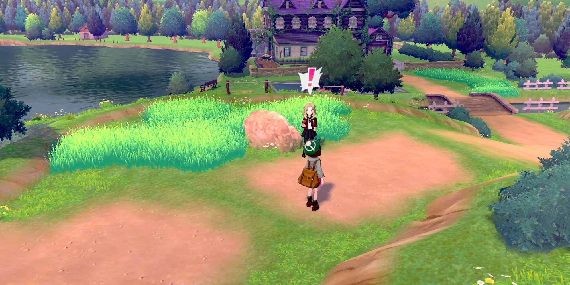 Nhân vật người chơi đi bộ trên một tuyến đường trong Pokemon Sword Shield, một huấn luyện viên khác xuất hiện