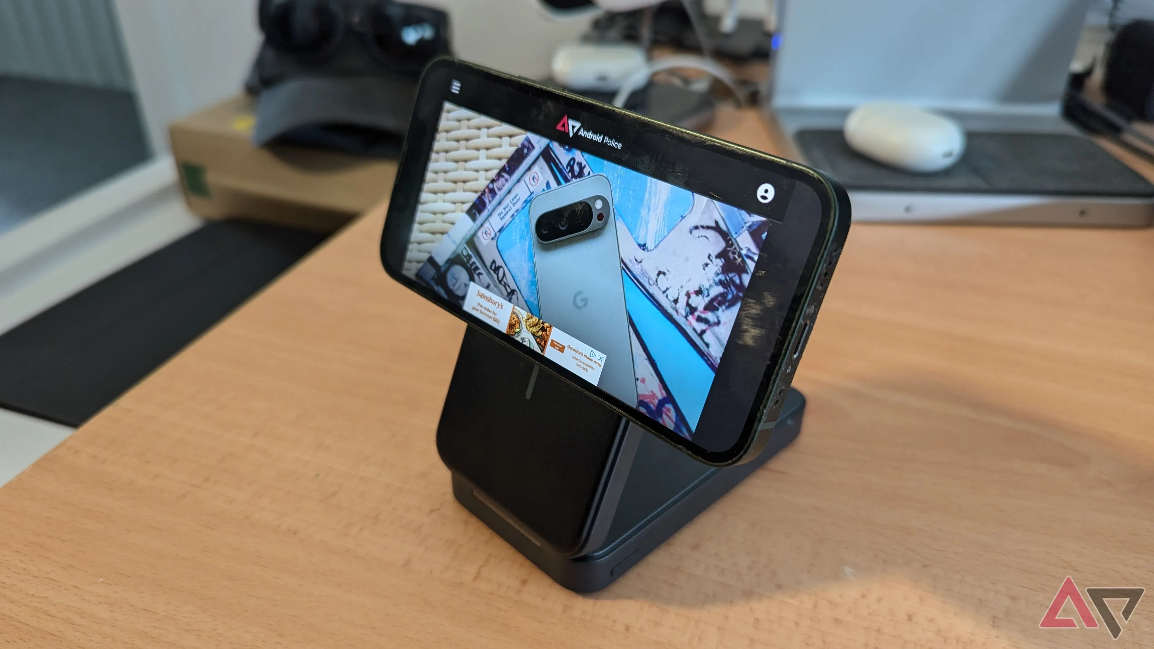 Anker MagGo 6,600mAh Power Bank with iPhone 13 mini on in landscape position on desk