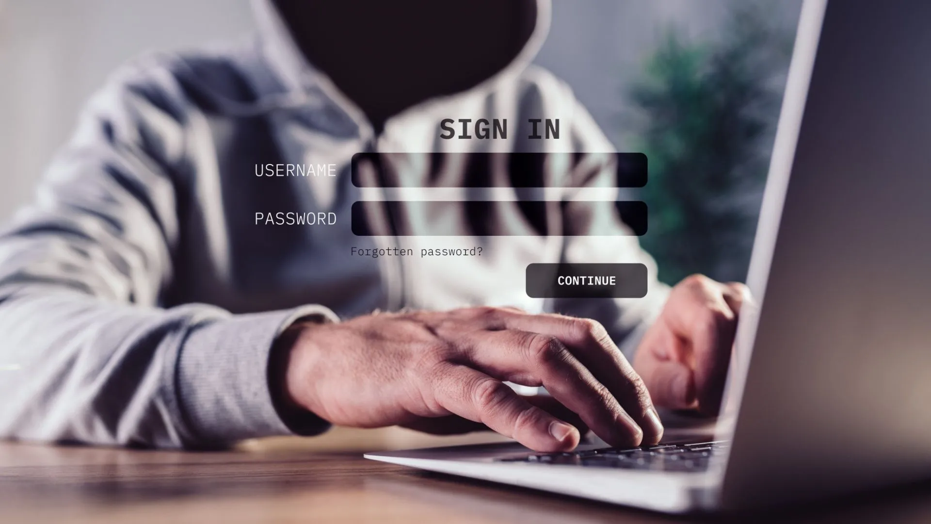 Hình tượng trưng hacker ngồi trước laptop, gợi ý rủi ro an ninh khi lộ mã nguồn lâu đời